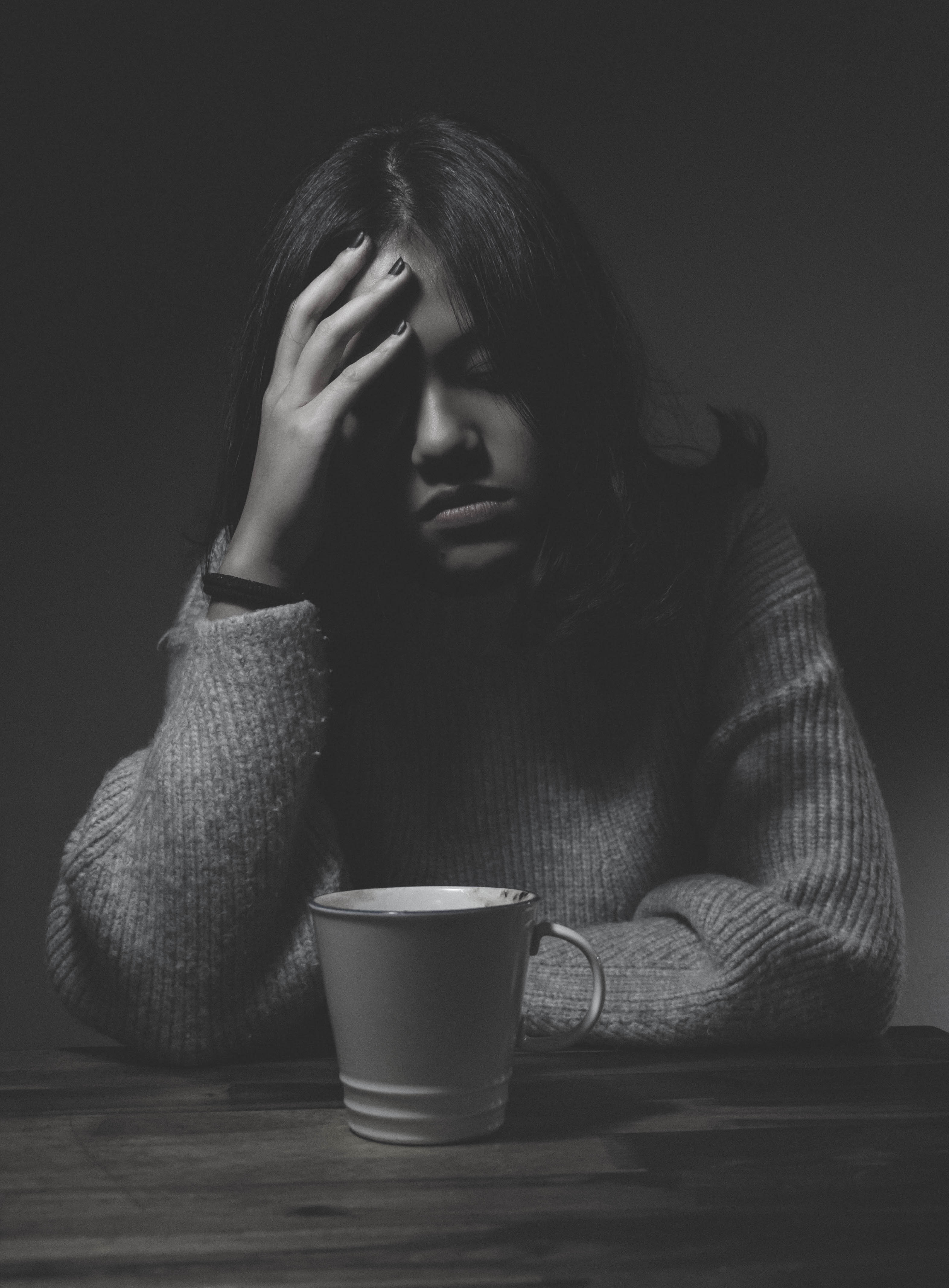 Worried  woman with mug black and white