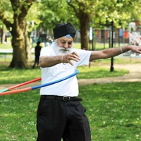 man exercising with hoop