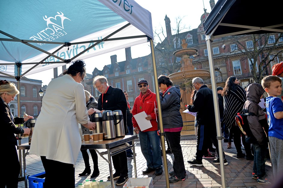 People gathered around an Active Health stall