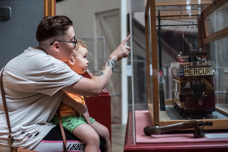 Mother and toddler looking at a museum display 
