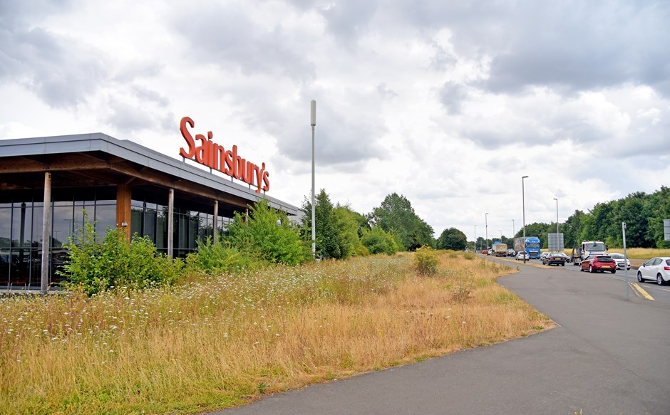 image of road verges with Sainsburys in the back ground 