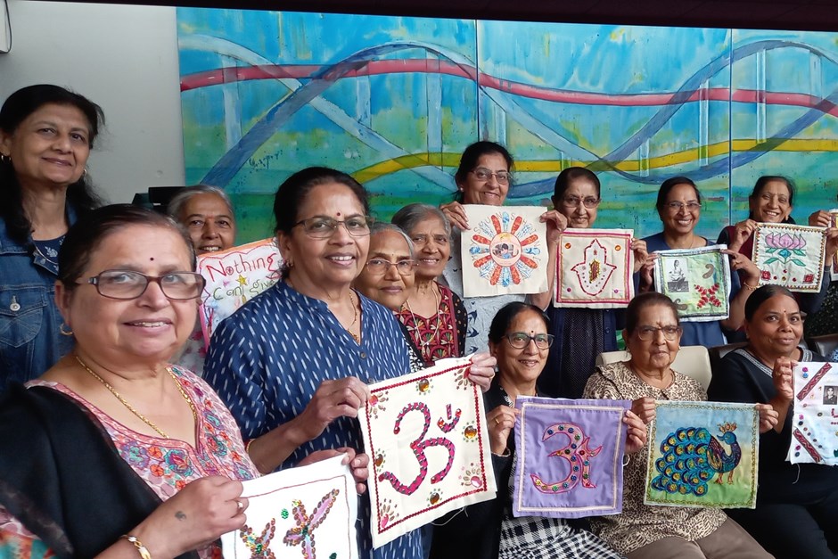 Group of women displaying embroidery