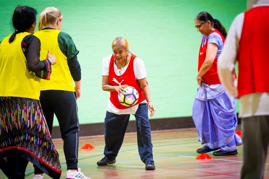 Older ladies playing basketball