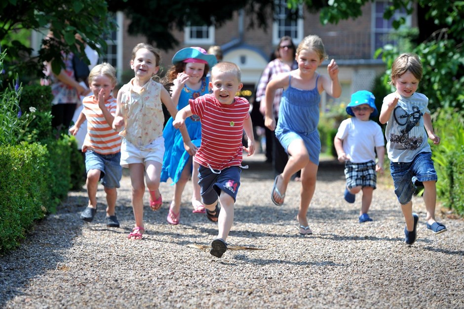 Children having a race in a sunny garden