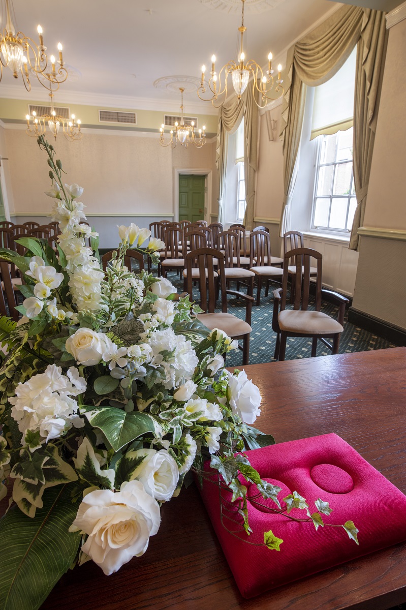 Flower arrangement and ring cushion in a ceremony room