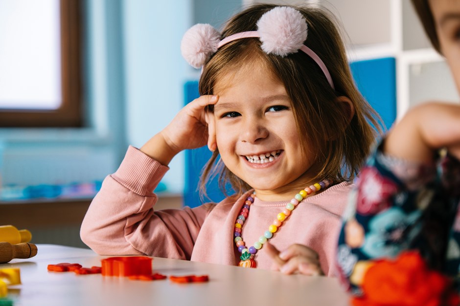 Smiling girl at activity table
